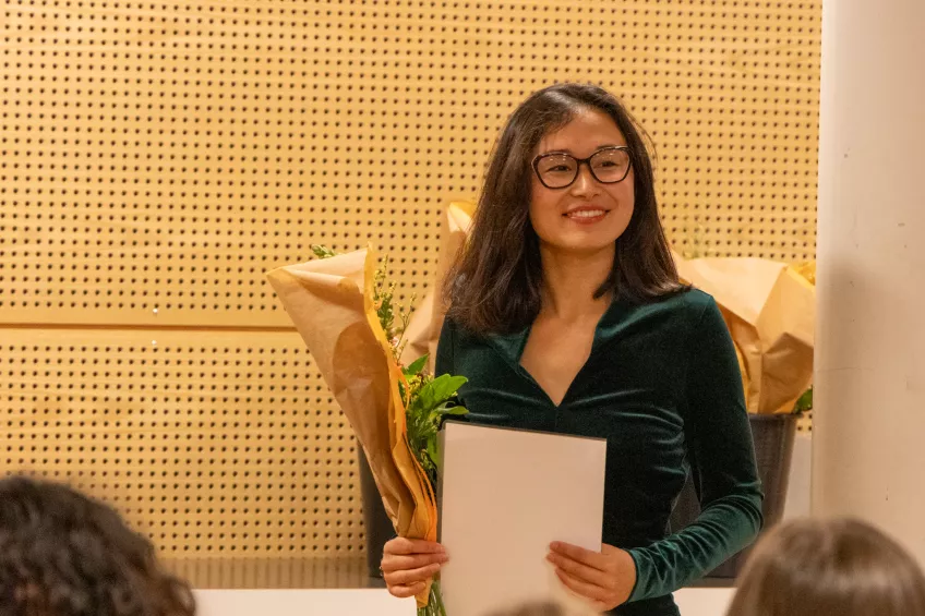 A person holding a sheet of paper.